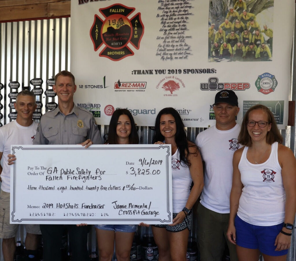 Donation check presented to the Georgia Public Safety Memorial Committee in honor of the Granite Mountain Hot Shots. Left is Andy Mccann; Lt Judd Smith, Vice Chairman of the Georgia Public Safety Memorial Committee; Jessica Andres; Jamie Armenta; Nicholas Armenta and Dani Walsh.